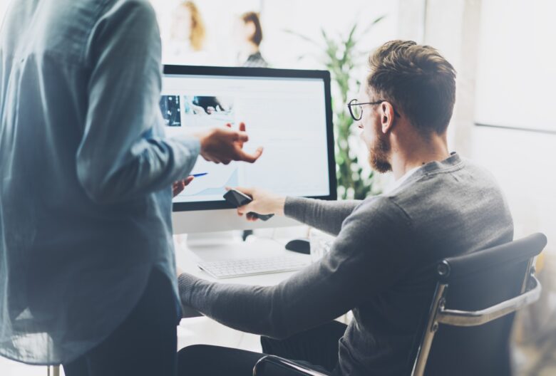 man reviewing credential document on computer