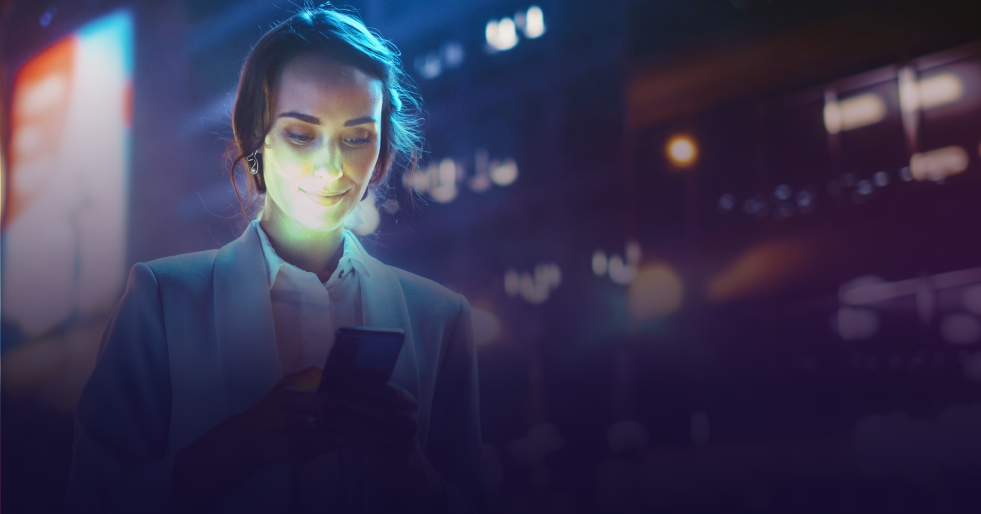 Woman holding phone and using the XP Group website designed for mobile