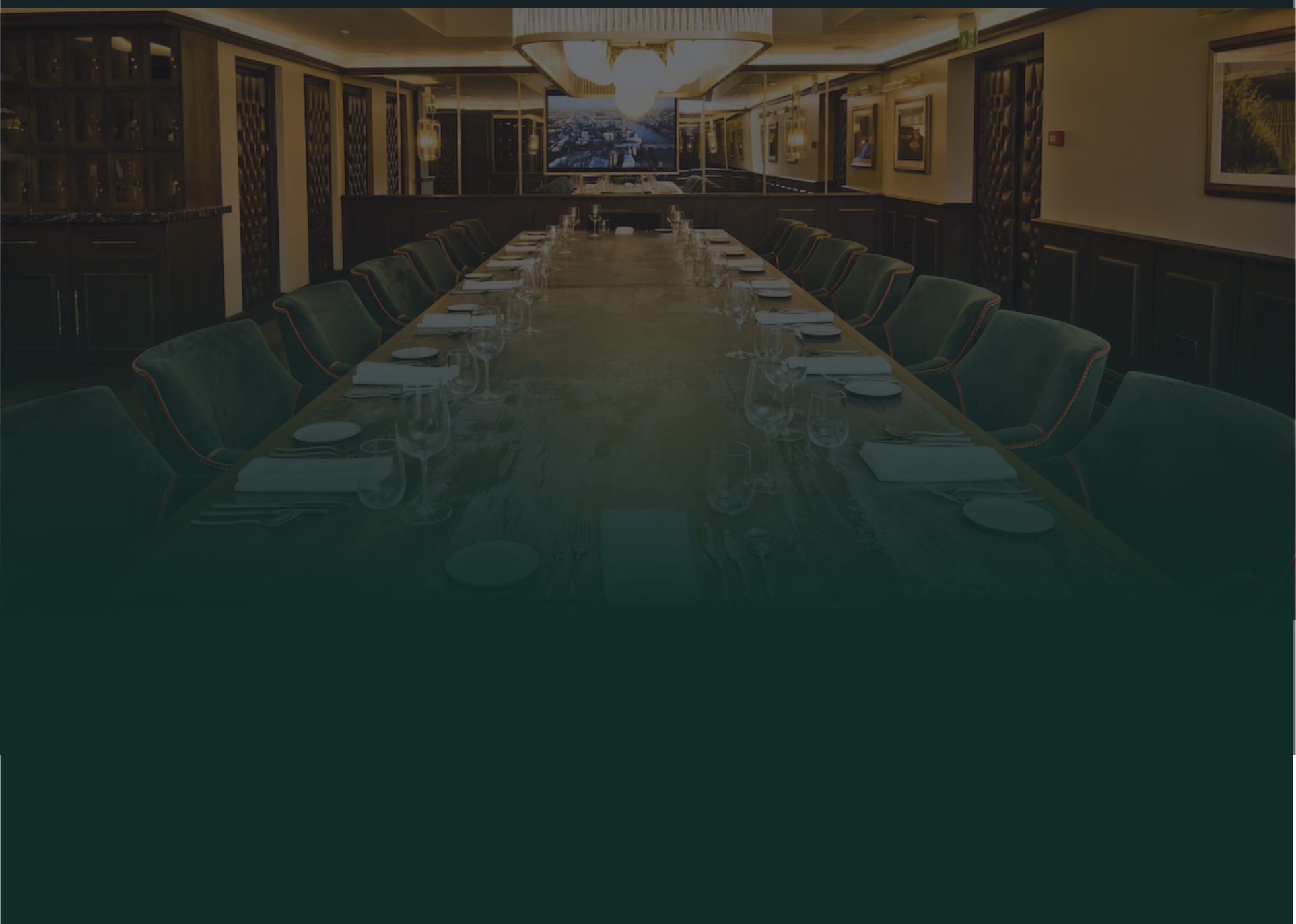 The inside of The Forest Hotel, including a long decorated table and many chairs either side