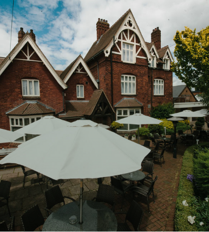 Forest Hotel location image of their outer building surrounded by trees and canopies