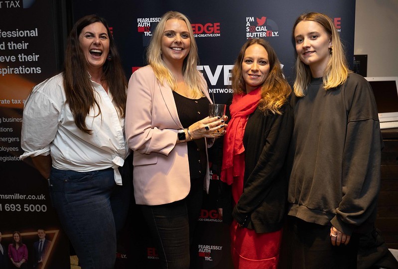 Karen, Lou, Liane and Ellie line up in front of an EDGE Creative banner during an EDGE networking event