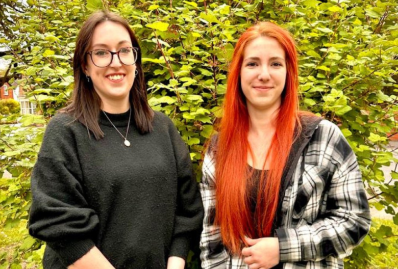 EDGE Creative's new team members Sophie and Irina standing in front of a bush