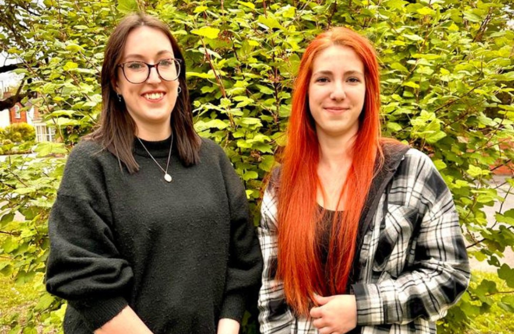 EDGE Creative's new team members Sophie and Irina standing in front of a bush