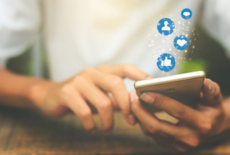 A person holding their phone influenced by social media seo while liking posts