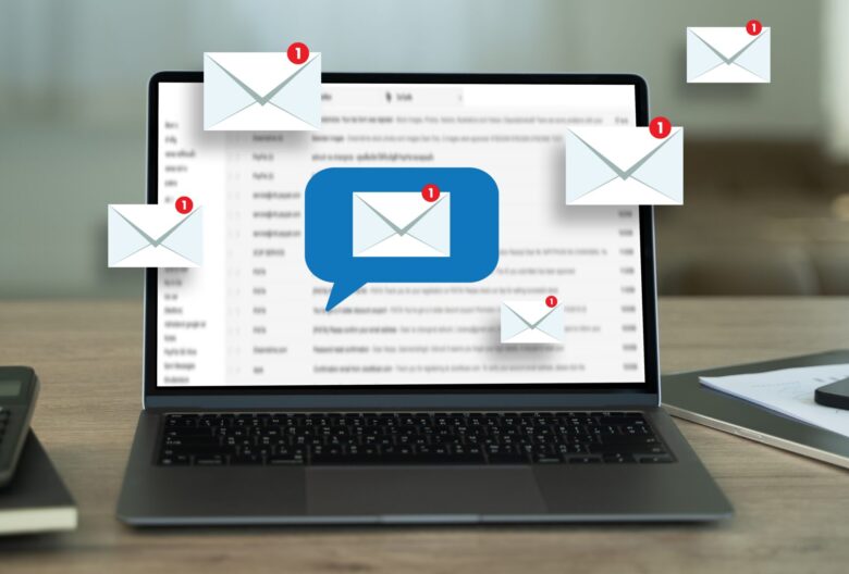 laptop with email icons.